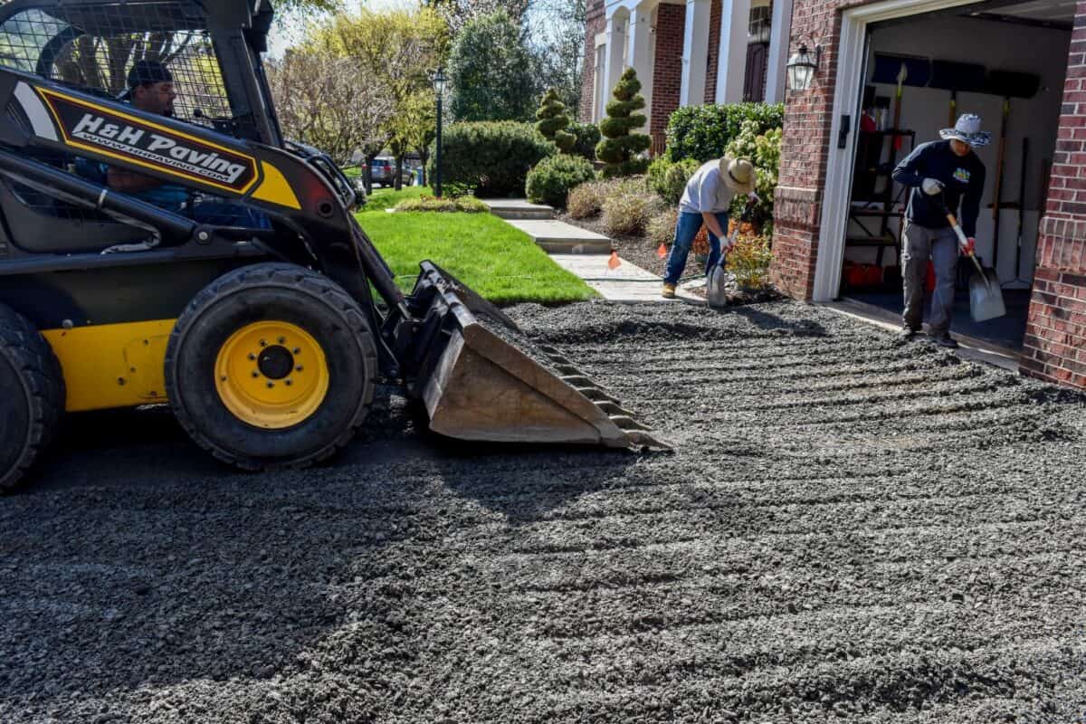 H&H Paving crew preparing a residential driveway for asphalt paving
