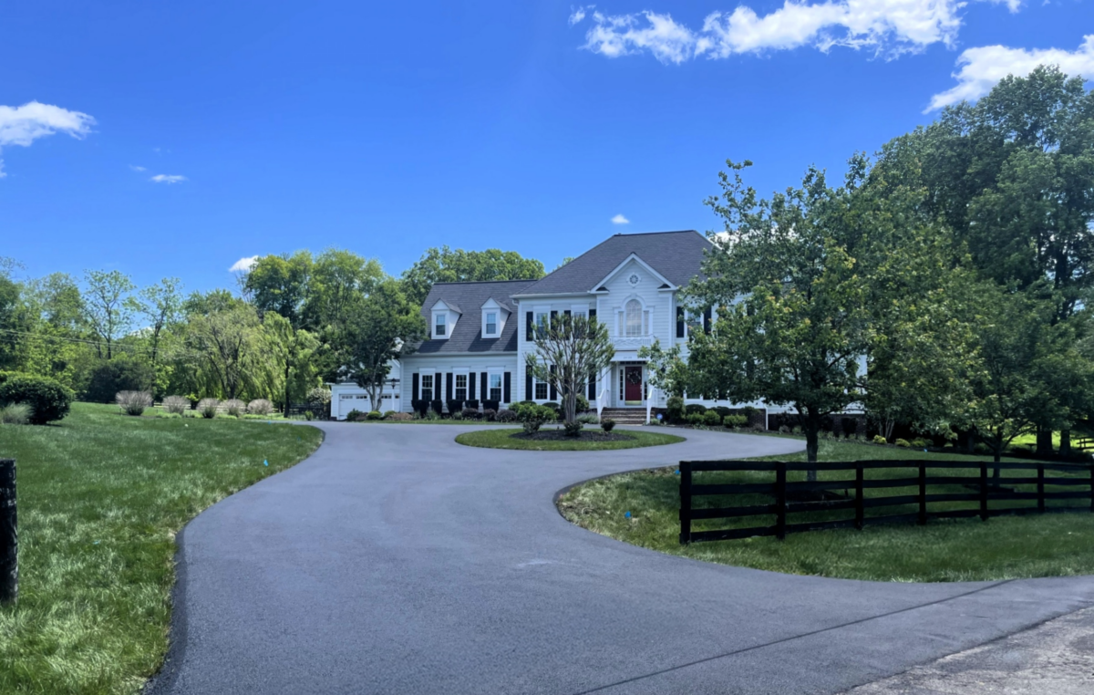 Newly paved asphalt driveway improving the curb appeal of a residential property